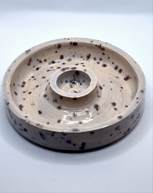 Candlestick in cream with lavender speckles on a neutral background 